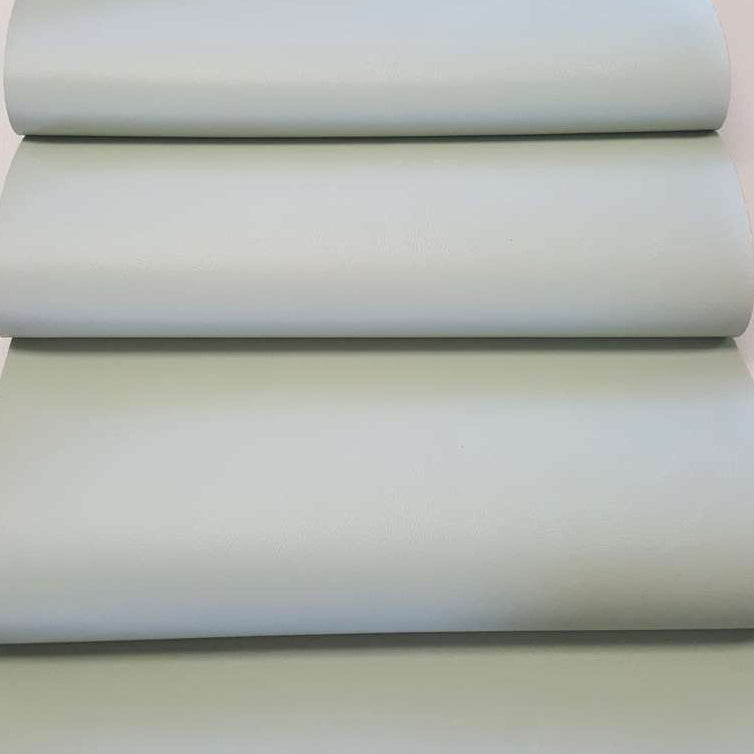 Stack of light green fabric swatches on a white background